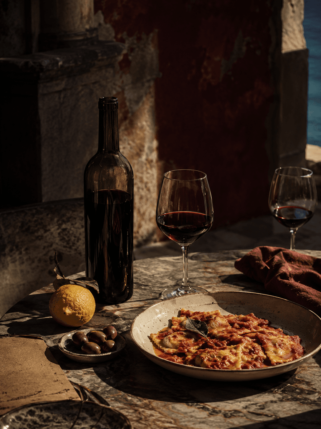 A wine bottle, glass and lemon on a marble surface next to a menu.
